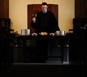 Newly-ordained Rev. Mark Vander Pol administers the Lord's Supper