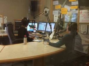 Bev De Vries took this picture through the production room window while Patricia and I were on the air.